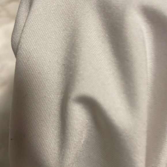 This is a great top the material is silky is a nice white almost never worn! - Picture 3 of 4